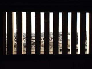 City behind a barred window in a jail