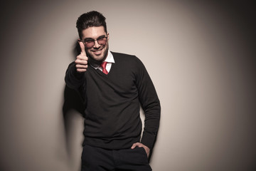 Happy business man showing the thumbs up sign.