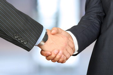 Close-up image of a firm handshake between two colleagues