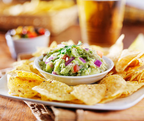 mexican guacamole with tortilla chips and beer