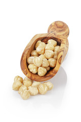 peeled and cleaned hazelnut kernels in wood scoop