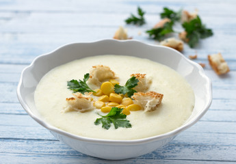 Vegetables cream soup with corn, croutons and parsley