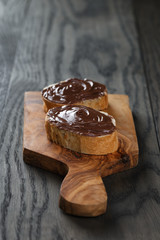 two baguette slices with chocolate hazelnut spread