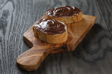 two baguette slices with chocolate hazelnut spread