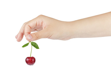 female teen hand holds cherry