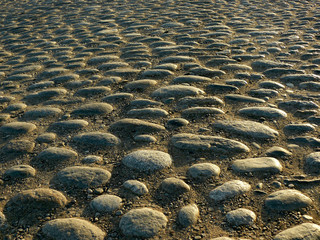 ancient cobblestone pavement in the rays of the setting sun