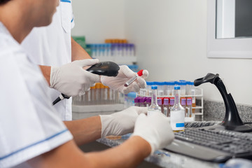 Technicians Scanning Specimens With Barcode Reader