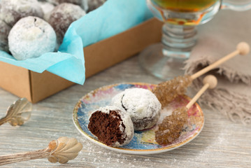 Chocolate homemade cookies in powdered sugar with tea