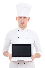 young man in chef uniform holding laptop with blank screen isola