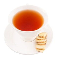 Ginger slices and a cup of tea over white background
