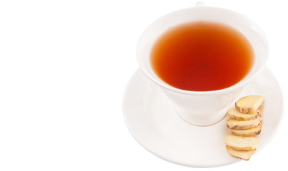 Ginger slices and a cup of tea over white background