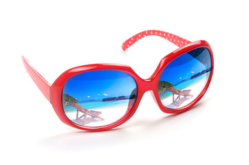 red sunglasses with a reflection of a beautiful  sea scape