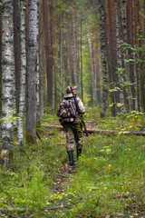 hunter with gun in the forest © rodimovpavel