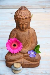 Foto auf Acrylglas Boeddha standbeeld op oud houten achtergrond met Zen stenen © trinetuzun