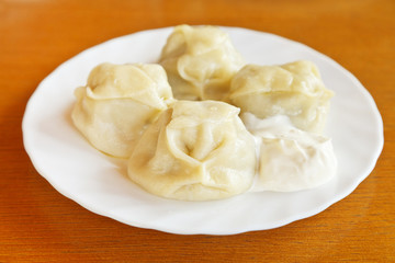 manti dumpling on white plate