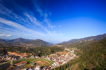 Fototapeta na wymiar Aerial view of clusters of buildings nestled in the green valley