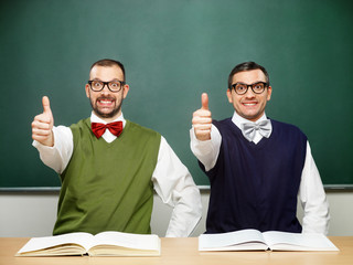 Two male nerds thumbs up