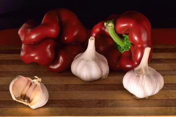 Bell peppers on wooden chopboard with garlic