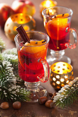 glass of mulled wine with orange and spices, christmas decoratio