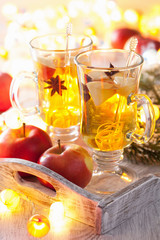 glass of mulled apple cider with  orange and spices, winter drin