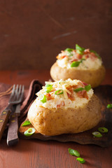 baked potato in jacket with bacon and cheese