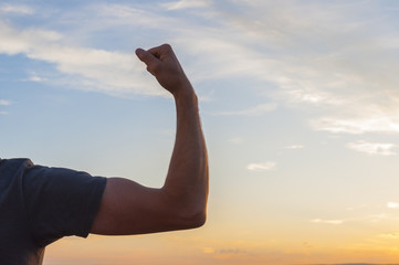Man posing at sunset, sowing biceps. Nature background - 72253842