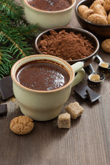 cup of hot chocolate and amaretti cookies on a wooden table