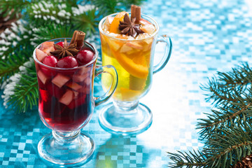 festive Christmas mulled wine and apple cider on blue background