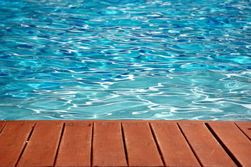 blue swimming pool with wood flooring stripes summer vacation