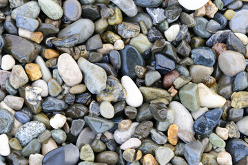 Composition of multicolored sea pebbles background