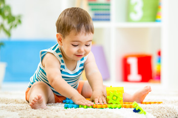 Fototapeta na wymiar child boy playing with block toys indoor