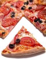 Tasty pizza with ham, tomatoes and olives with a slice removed