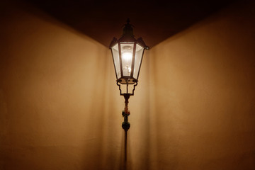 Retro style lantern illuminating wall