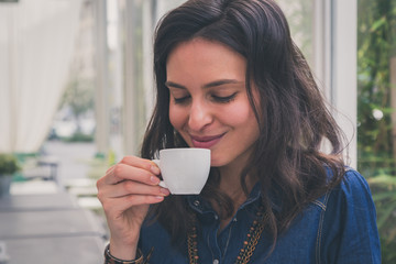 Pretty girl drinking a cup of coffee