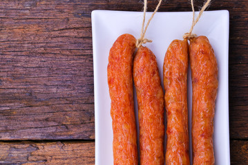 Chinese Pork Sausages in plate on wooden table