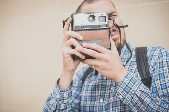 handsome hipster casual multitasking modern man with vintage cam