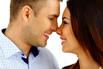 Happy young couple looking at each other over white background