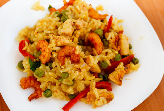 paella with shrimps on white plate