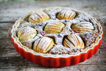 Apple pie with walnut creme, dusted with sugar in pie pan