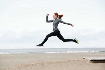 Fit young woman running and jumping