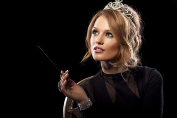 Beautiful young woman posing with a crown on her head