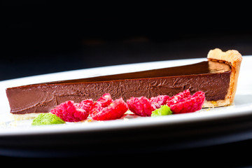 Delicious Piece of Chocolate pie. Chocolate cheesecake with rasp