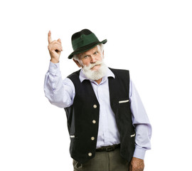 Old bavarian man in hat pointing upwards isolated