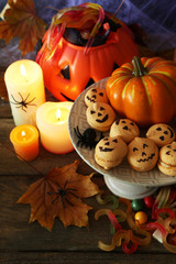 Composition for Halloween with sweets on wooden table