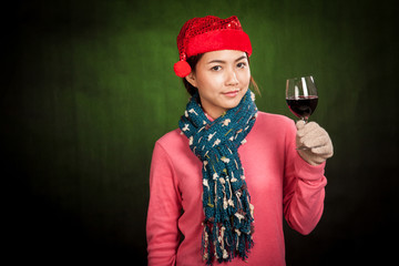 Asian girl with christmas hat and glass of wine