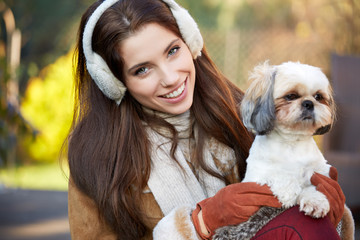 young woman playing with a small dog