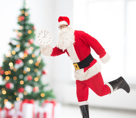 man in costume of santa claus with clock