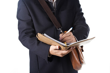 business man with briefcase and writing the book