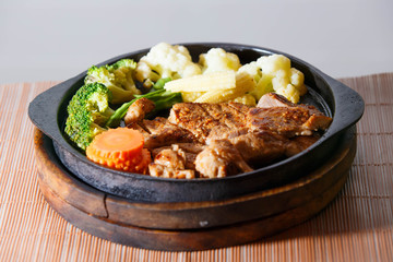 Juicy grilled pork chop (neck cut) with vegetables