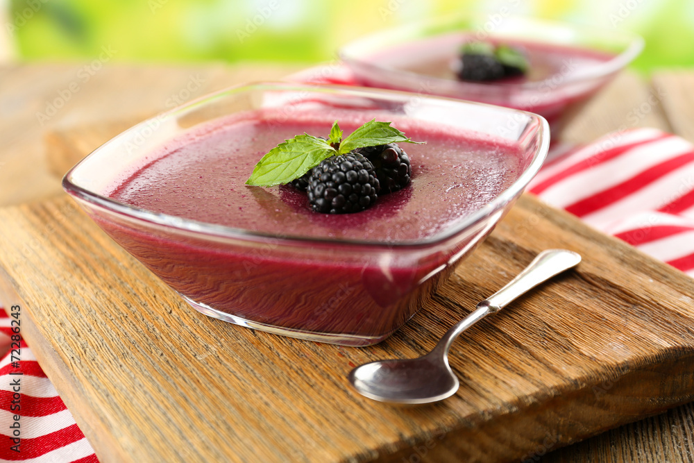 Sticker delicious berry mousse in bowls on table close-up